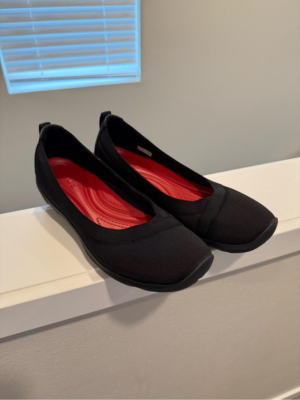 Women’s size 11 CROCS Black Flats with Red Insole - Slip-On Comfort